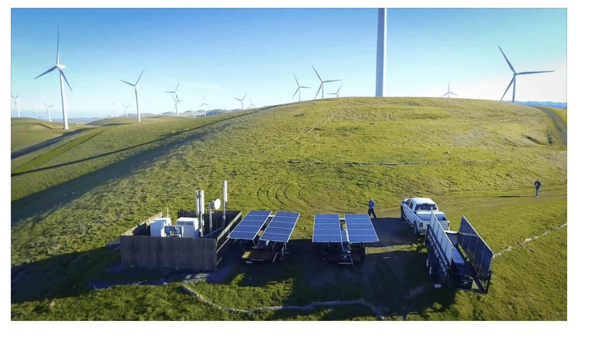 aerial picture of two solar power wagons set up on a hill